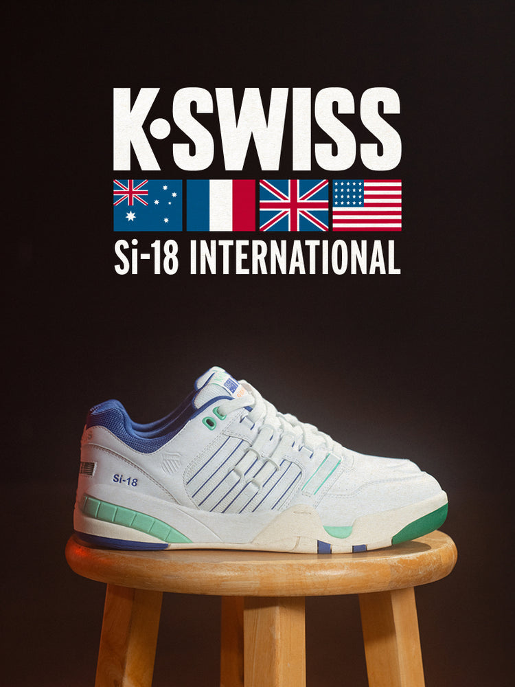 Stylish K-Swiss Si-18 sneaker with blue, green, and white accents on stool with flags and branding