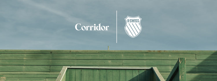 Green wooden structure under clear sky with Corridor and K-Swiss logo on the side.