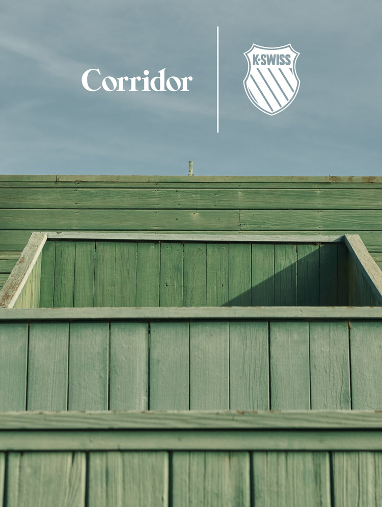 Green wooden structure under clear sky with Corridor and K-Swiss logo on the side.