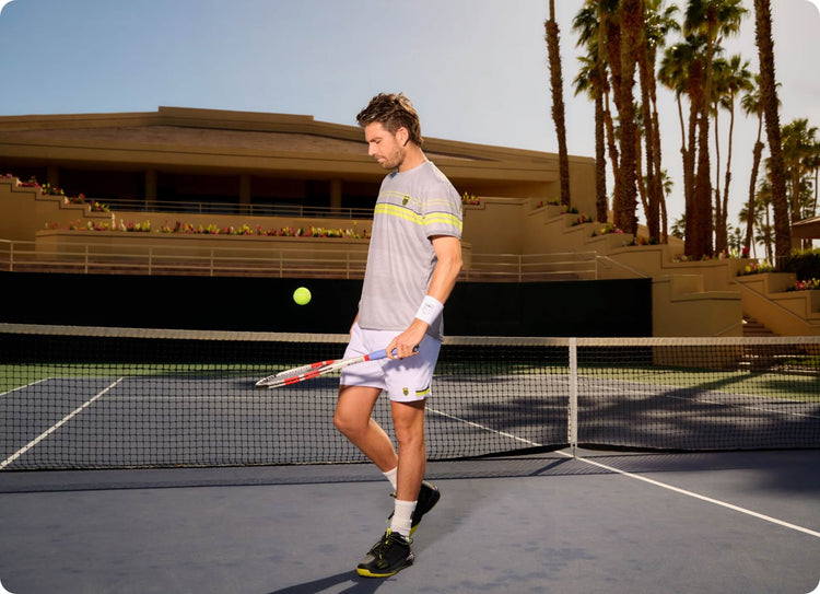 Image of a tennis player with a racket and tennis ball on a court