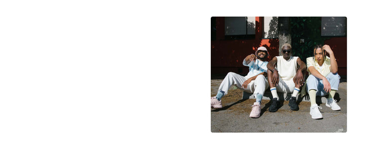 Image of three men sitting on a street curb wearing K-Swiss shoes