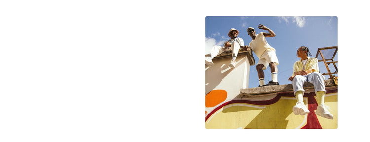 Image of three young men sitting and standing on a wall wearing K-Swiss shoes