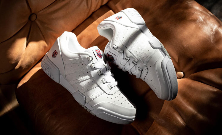 Image of the K-Swiss Gstaad shoes on a brown leather couch
