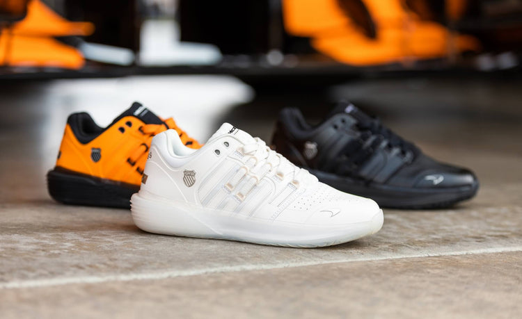 Image of three K-Swiss x McLaren shoe styles on a garage floor