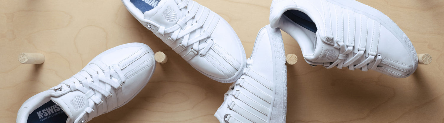 4 White Classic VNs on wood peg background. Shoes are laid out in different postions.