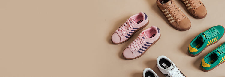 Colorful K-Swiss Court Tiebreak sneakers arranged on a beige background