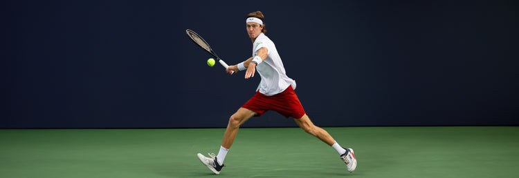 Andrey Rublev playing tennis while wearing K-Swiss tennis shoes