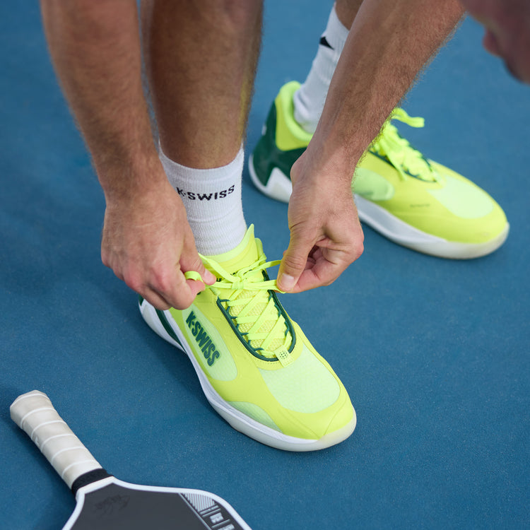 Green K-Swiss K-Frame pickleball shoes on a pickleball court.