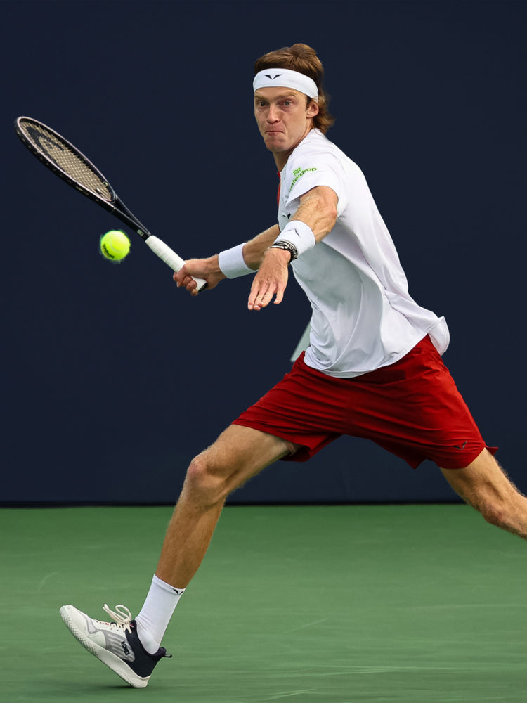 Andrey Rublev playing tennis while wearing K-Swiss tennis shoes