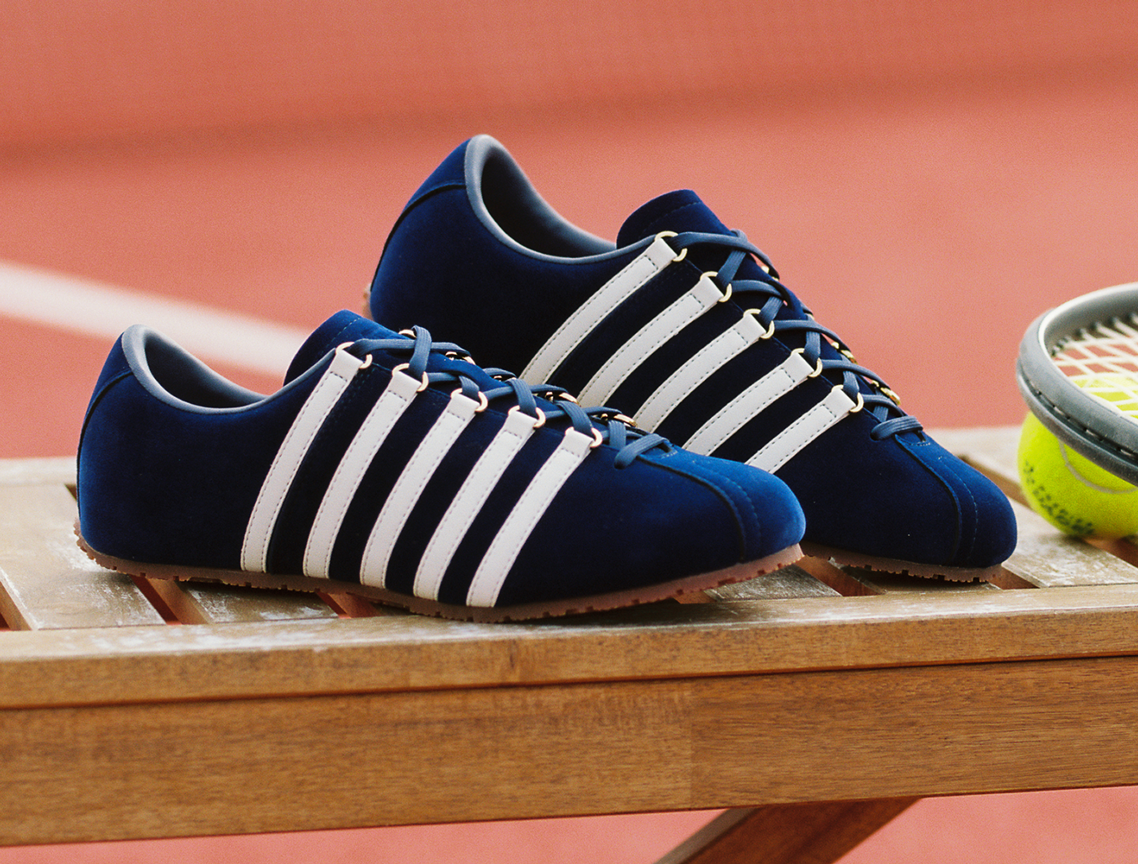 BEFORE THE CLASSIC 60TH navy suede sneakers with white stripes on bench