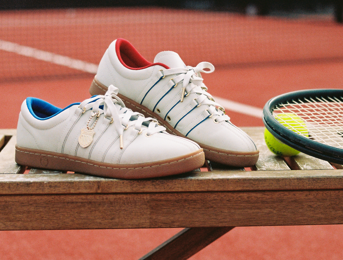 CLASSIC 66 NXT 60TH white leather sneakers on tennis court bench