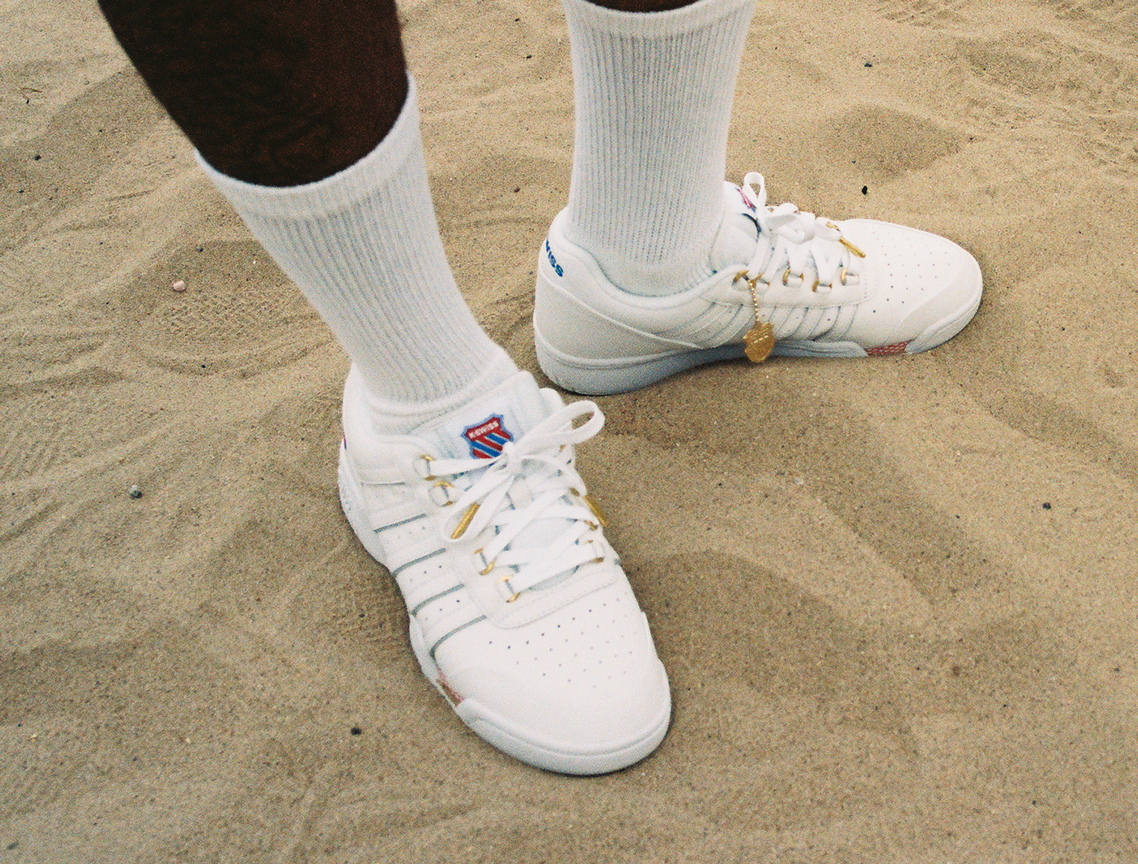GSTAAD 60TH white leather sneakers worn on a clay tennis court