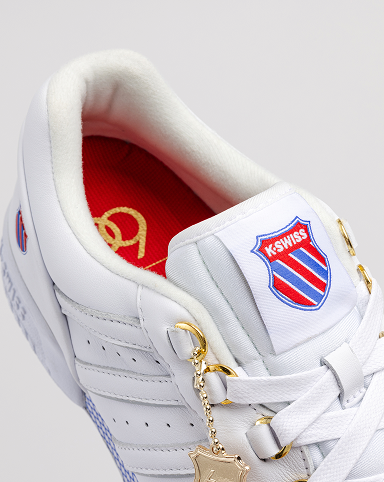 Close up of GSTAAD 60TH white leather sneaker with gold lace charm