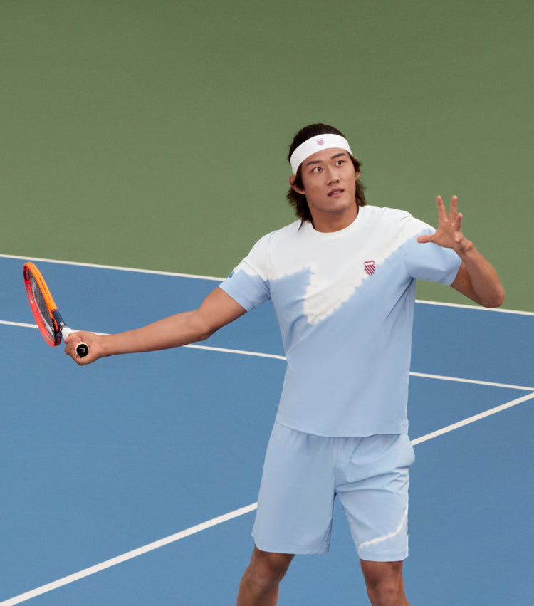 Zhizhen Zhang playing tennis in K-Swiss clothing