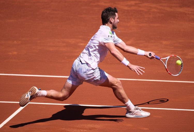 Cameron Norrie playing tennis on a clay court in K-Swiss Ultrashot tennis shoes