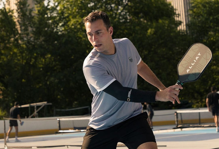 Matt Manasse playing pickleball in a grey K-Swiss t-shirt