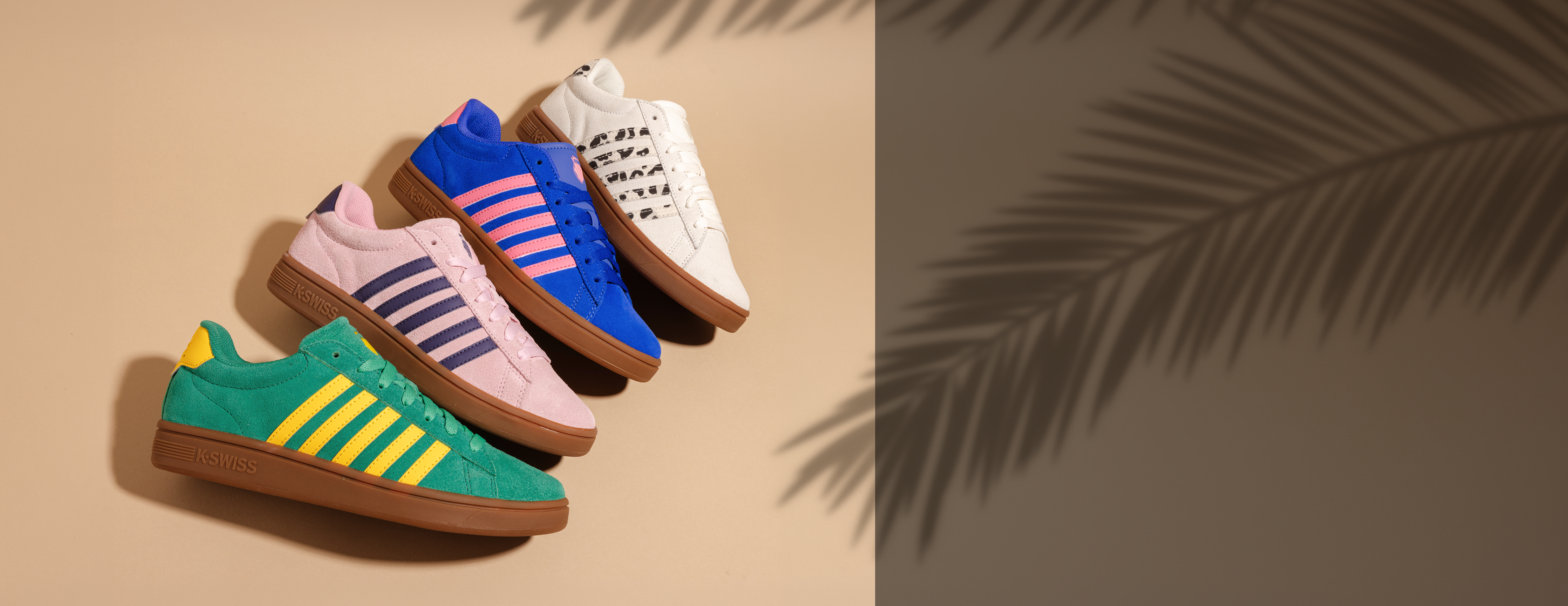Colorful sneakers on a beige background with a palm leaf shadow
