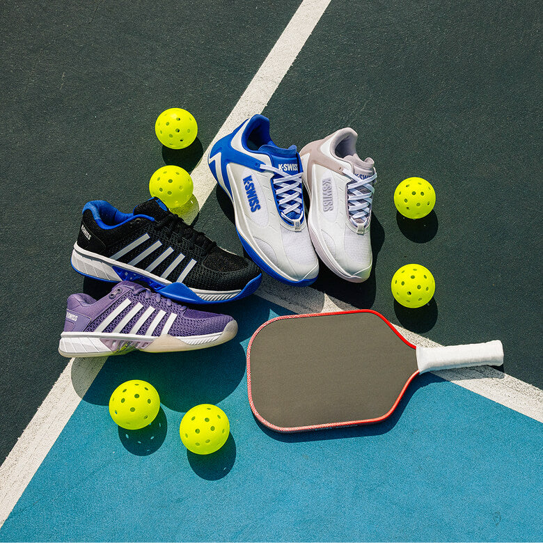 Pickleball shoes, paddle, and balls on a pickleball court