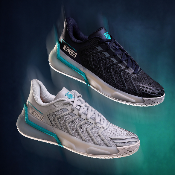 Two K-Swiss athletic sneakers shown floating against a dark teal and black gradient background. The top shoe is black with white and teal accents, and the bottom shoe is light gray with white and teal accents.