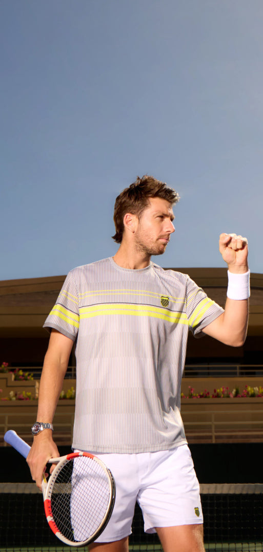 Cameron Norrie holding a tennis racket wearing K-Swiss clothing