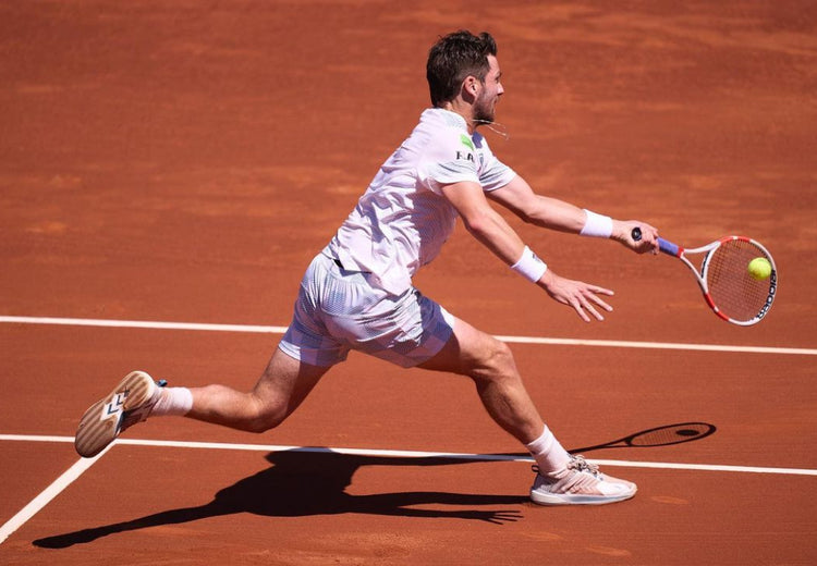 Cameron Norrie playing tennis on a clay court in K-Swiss Ultrashot tennis shoes