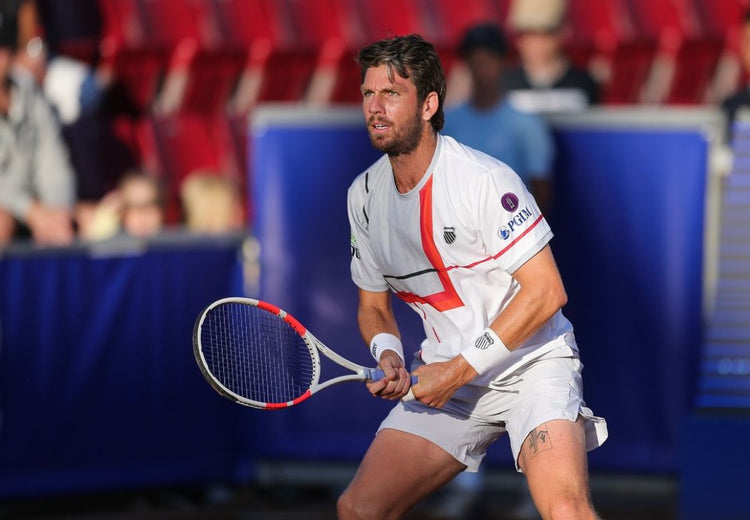 Cameron Norrie playing tennis while wearing K-Swiss clothing