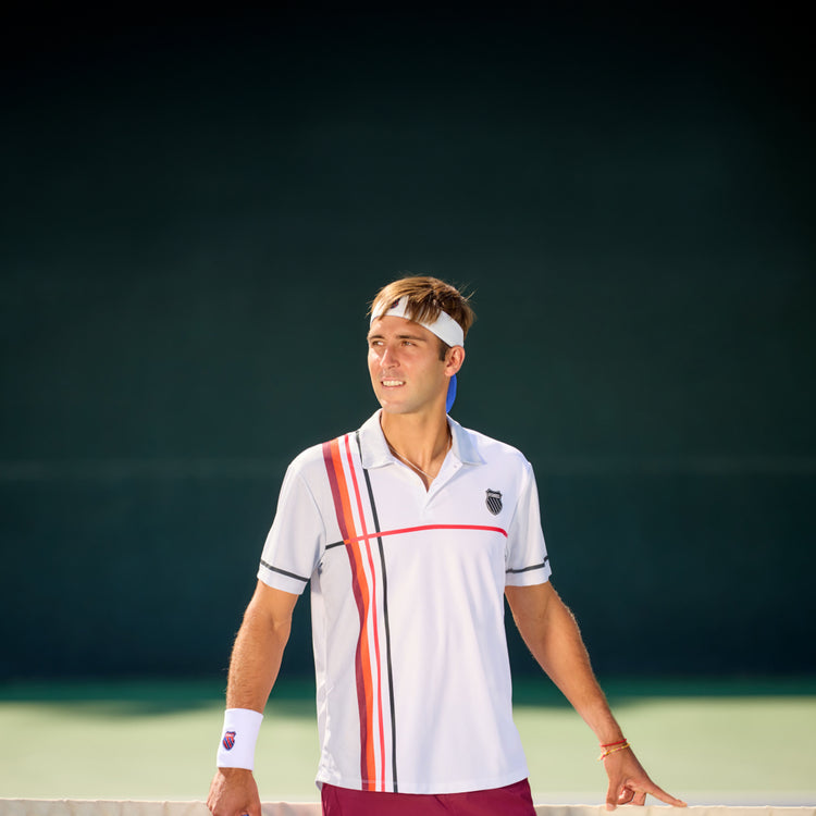 Man on a tennis court wearing K-Swiss clothing and accessories