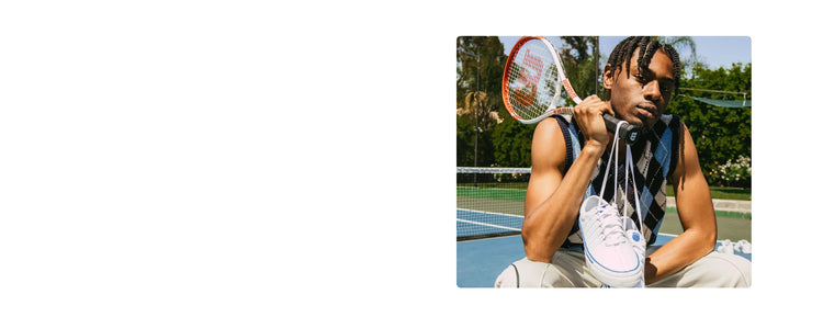 Image of a man holding a tennis racket with a pair of white K-Swiss shoes tied around the handle